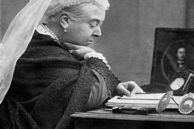 Queen Victoria signs the Australian constitution