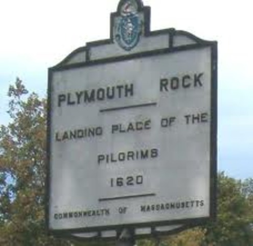 The Mayflower lands at Plymouth Rock.