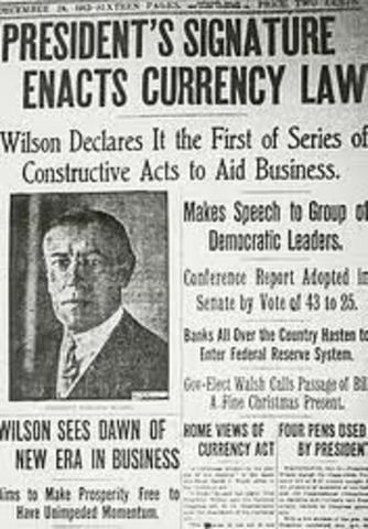 President Wilson signs the Federal Reserve Act