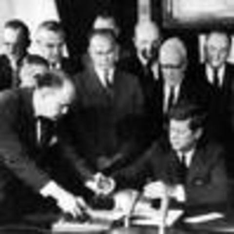 Signs treaty banning nuclear weapon testing