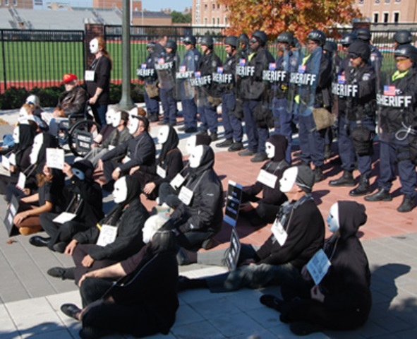 Masked Protesters Sit Outside Moody Coliseum