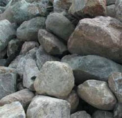 Charles Hollis hews granite from boulders in town and hauls them to boston