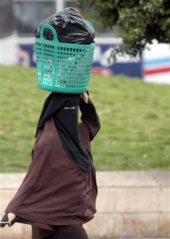 Veiling of women in public is banned by the Shah.