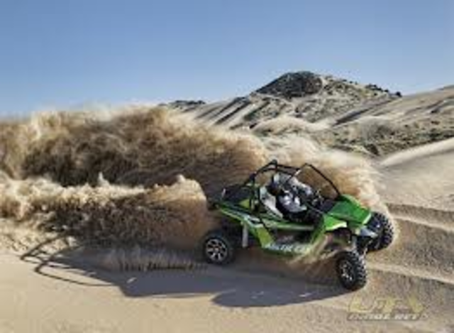 Drive a 4-wheeler in the sand dunes