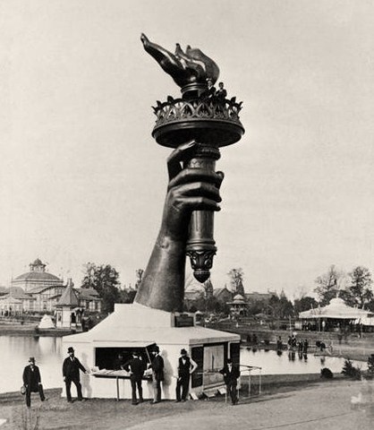 Bartholdi completes the Statue's hand holding the torch!