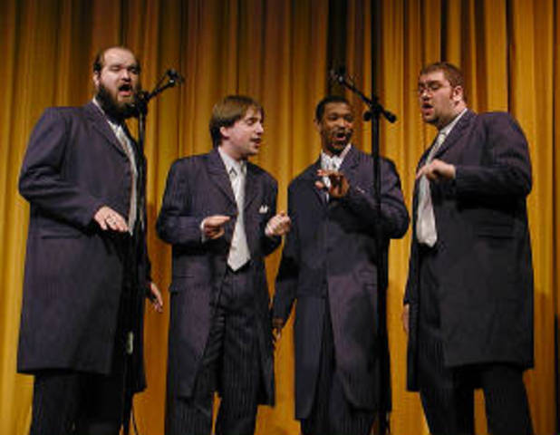 Forms Men in Black Barbershop Quartet
