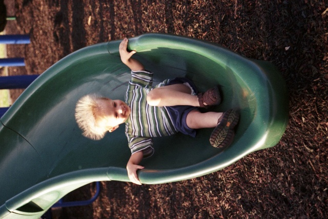Has fun on a slide