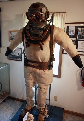 German-born inventor Augustus Siebe seals the Deanes brothers diving helmet.
