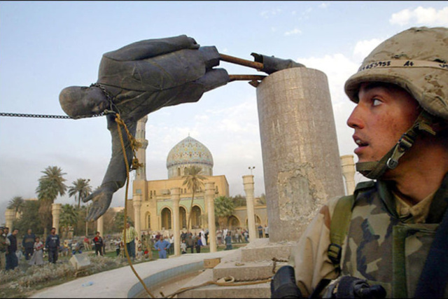 The statue of Saddam Hussein replaced with an american flag