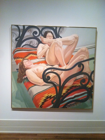 Two Female Models Reclining on a Cast-Iron Bed