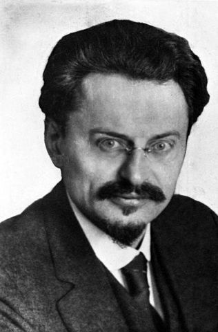 The new Russian gov't, represented by Trotsky and under orders from Lenin, sign the Treaty of Brest-Litovsk