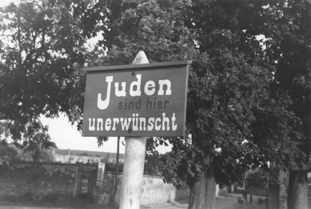 During the summer "Jews Not Wanted" posters start to appear on restaurants, shops, and on village entrance signs.