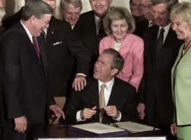 President Bush signs a $1.35 trillion tax cut into law