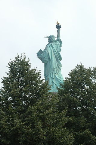 The Statue of Liberty arises in New York