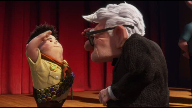 Carl presents Russell with his assisting the elderly badge.