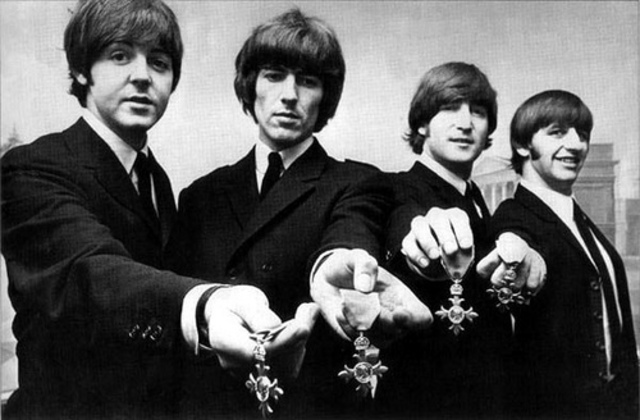 The Beatles are decorated with the Order of the British Empire (MBE) by the Queen