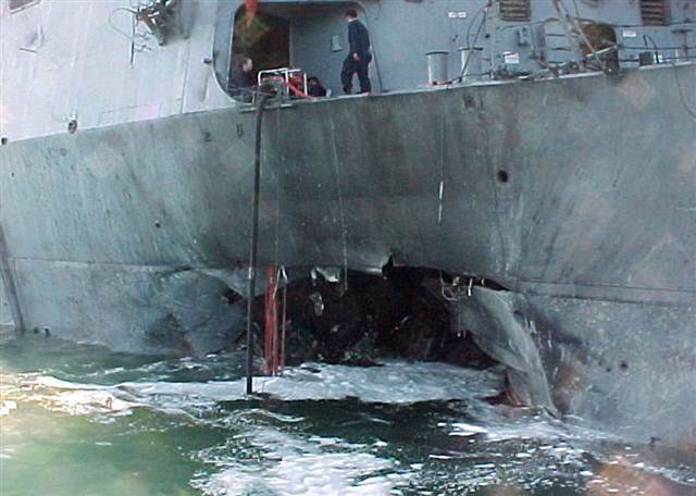 USS Cole is badly damaged by two suicide bombers