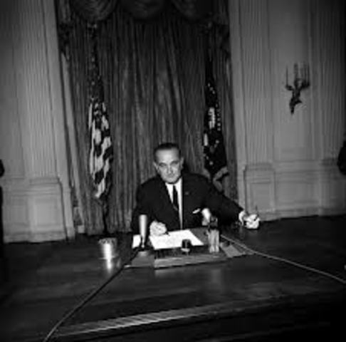 President Johnson signs the Resolution