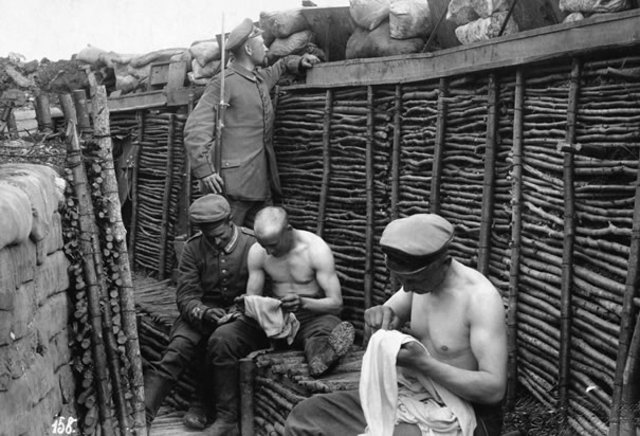 Soldiers Picking Lice From Clothes