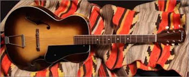 Purchased his first guitar