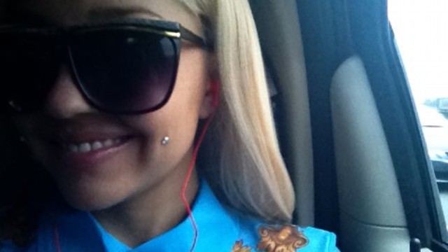 Reveals cheek piercings