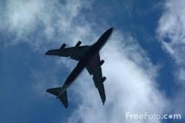 The plane flys over the community