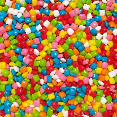 A gum maker covered small candy peices in chicle gum. The product was called Chiclets.