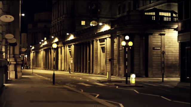 This wide shot makes the city setting of the video clear, the street lamps adding to the ambience of the urban setting.