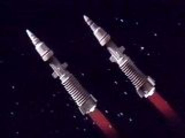 The Heart of Gold narrowly avoids the planetary defense missiles.