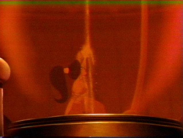 Jasmine is trapped in sand hourglass while Aladdin tries to get back the lamp.