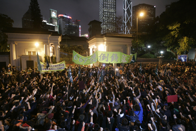 Hundreds of protesters opposed to the rail link stages a sit-in outside Government House