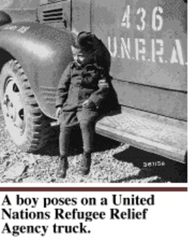 A boy poses on a United Nations Refugee Relief Agency truck