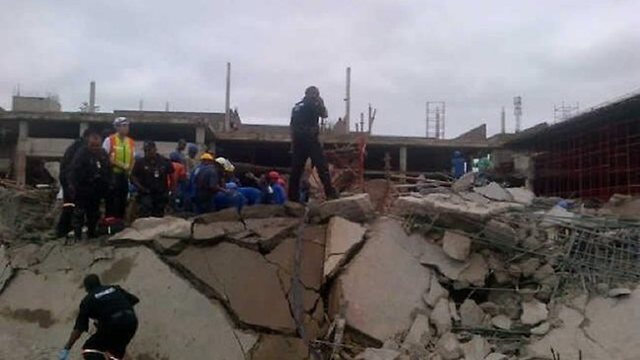 Rescue dogs sniff for survivors in South African mall collapse