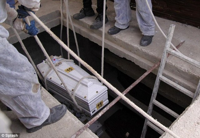 Tiny coffin of Lampedusa boat tragedy victim with a teddy on the lid among dozens buried in anonymous vaults despite Italian Prime Minister's promise of a state funeral