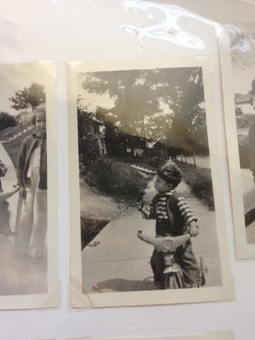 James rides on his tricycle at age three