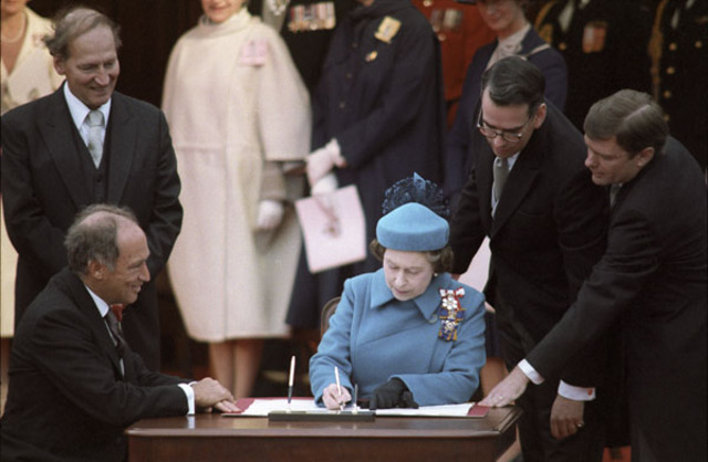 Constitution Act is signed by Queen Elizabeth
