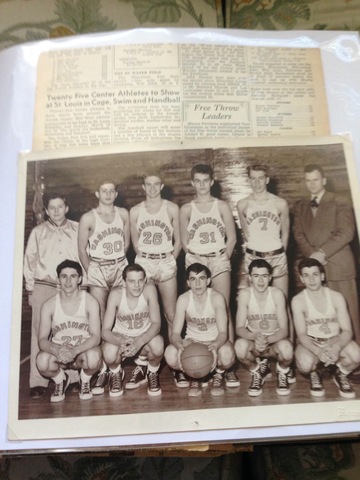 James posing with the varsity basketball team