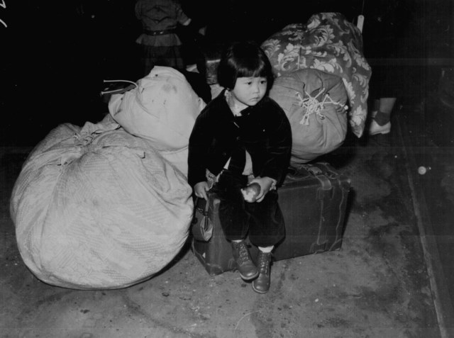 Young Japanese American waitig for shipment to interment camp
