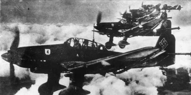 Hitler announces the creation of a new air force and began a draft that expanded the German army from 100,000-550,000 violating the treaty of Versailles