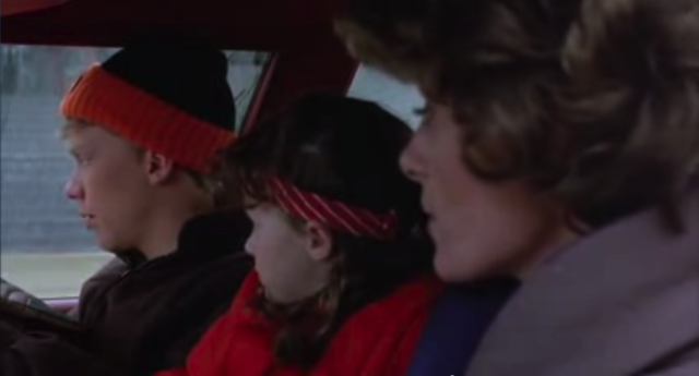 Medium shot from right car window of The Brain