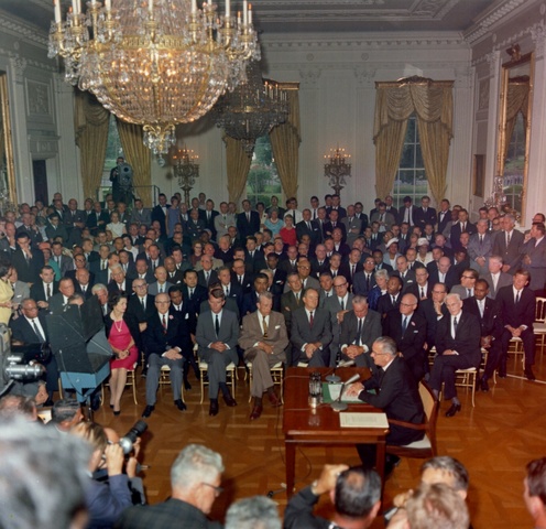 President Johnson signs the Civil Rights Act.