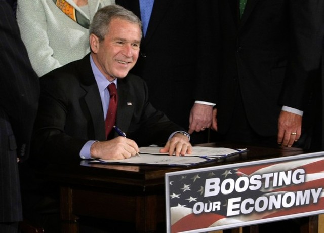 President Bush signs the Economic Stimulus Act of 2008 into law.
