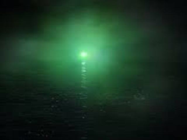 Nick sees Gatsby for the first time