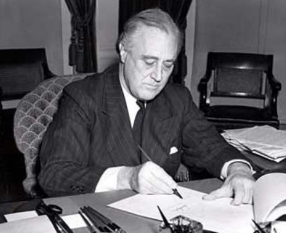 Presidents Roosevelt signs the Lend-Lease Bill