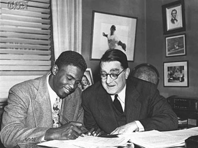 Branch Rickey signs Jackie Robinson