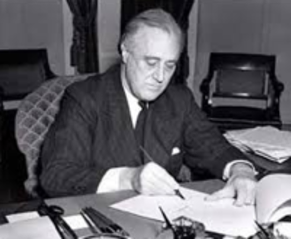 President Roosevelt Signs The Lend-Lease Act