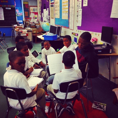 Henry volunteering his time to help young elementary students to read