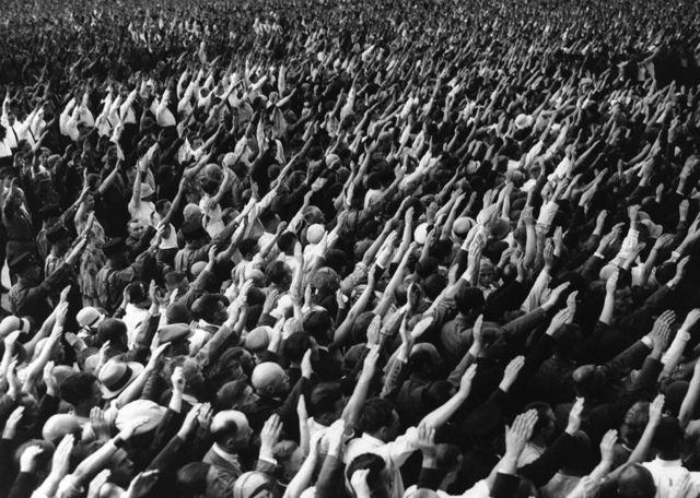 Hitler openly defies the Treaty of Versailles