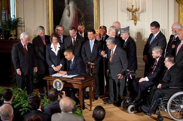 President Obama signs health reform bill into law.