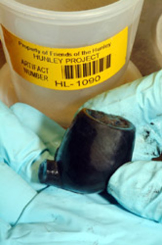 A wooden pipe. This pipe still had tobacco still in bowl.Archaeologists begin uncovering the personal belongings of the crew.